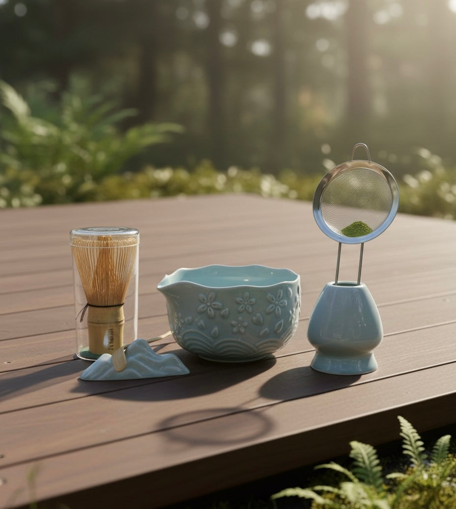 Ceramic tea-making set on a wooden deck with a natural background